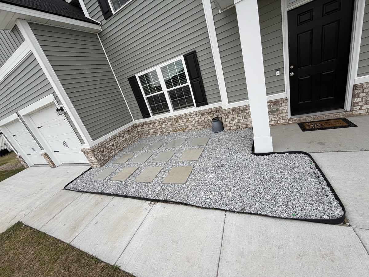 Paver and gravel hardscaping with garden bed care by A&P Lawn Care in Hinesville, GA